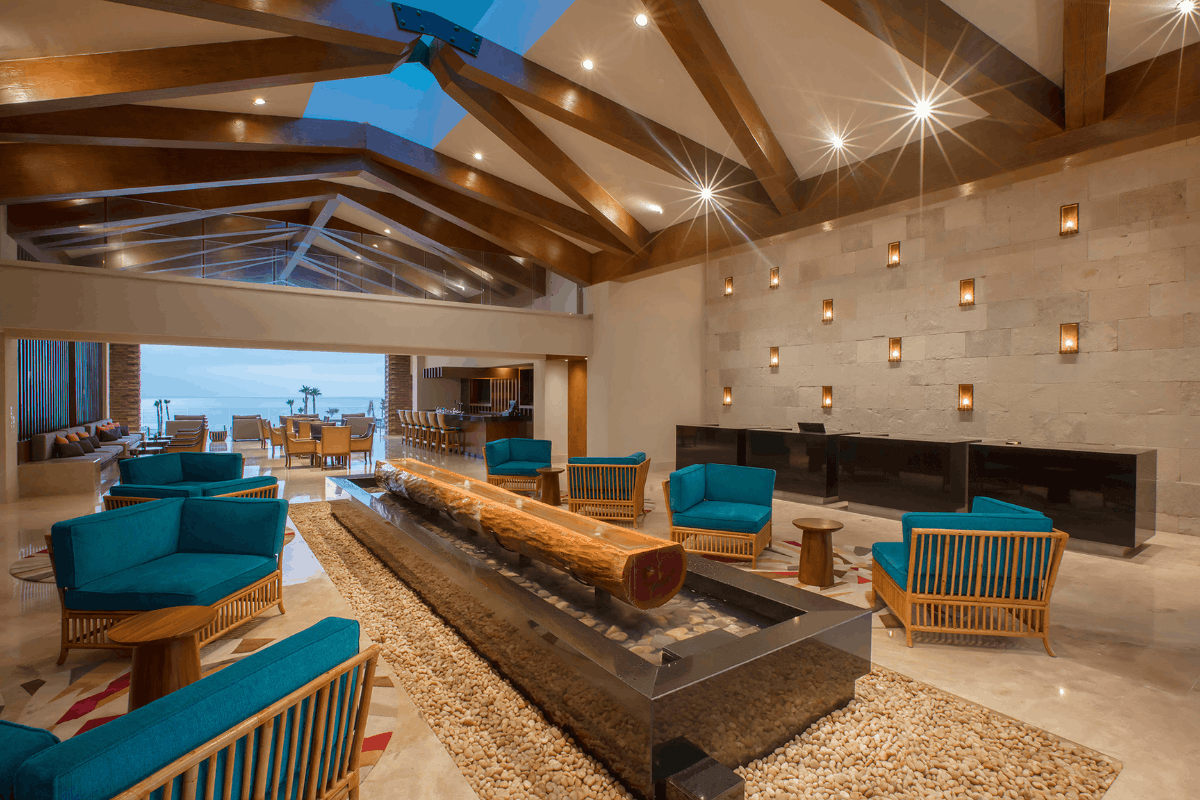 Lobby at Krystal Grand Los Cabos with modern design, seating areas and oceanfront access.